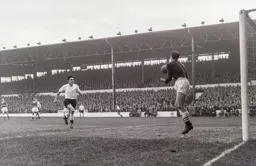 Reg Matthews is about to catch the ball as Gordon Turner races in