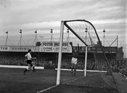 Allan Brown charges in as Villa keeper Nigel Sims make a one handed catch