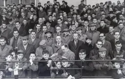 One supporter in the main stand enclosure finds his early edition of the Saturday Telegraph interesting reading