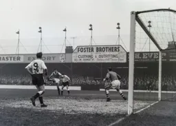 Jimmy Adam attempts to get his head on the ball after Len Willis had completly miskicked