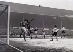 Dave MacLaren fists the ball away from Bob Morton