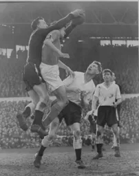 Ron Baynham makes a clean catch under pressure from Ray Charnley