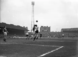 A clash of heads as Gordon Turner gets up for a header