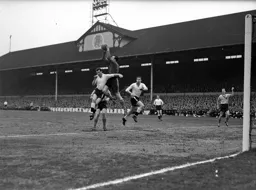 City keeper Sandy Kennon safely catches the ball under pressure from Bob Morton and Allan Brown