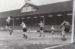 Roy McCrohan heads the ball clear for City before Bob Morton can react