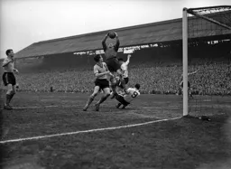 Norwich keeper Sandy Kennon manages to grab the ball