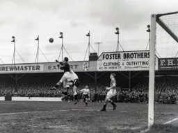 United keeper Harry Gregg punches the ball clear. Barry Hawkes watches in the background