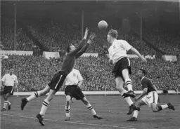 Ron Baynham reaches for the ball.