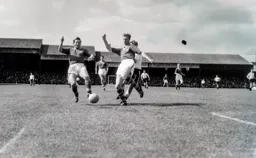 Leeds defender Jack Charlton first to the ball