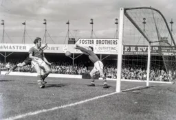 Leeds goalkeeper Ted Burgin about to grab the ball