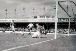 Leeds goalkeeper Ted Burgin saves with his knees