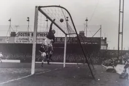 Spurs keeper Bill Brown tips the ball over