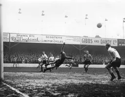 Ron Baynham dives across goal