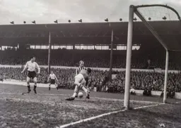 West Brom goalkeeper Jock Wallace drops on the ball watched by Albion's Don Howe and the Town's Joe McBride