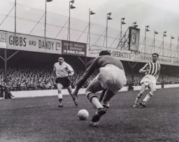 West Brom goalkeeper Jock Wallace picks up the ball watched by Gordon Turner and Bobby Robson