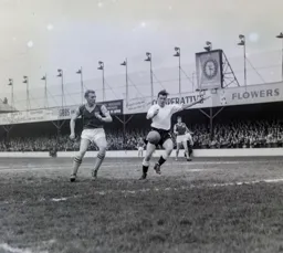Joe McBride beats a young Bobby Moore to fire in the second goal