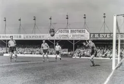 Norwich goalkeeper Sandy Kennon safely gathers the ball