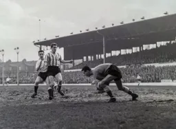 Jim Fleming hides behind the defender waiting for a slip up