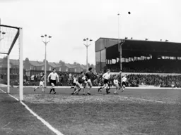 Swans keeper Noel Dwyer looks to clear the ball