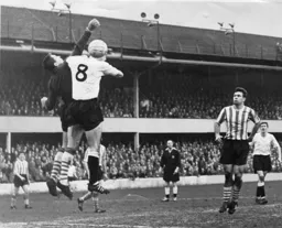 Alec Ashworth challenges the Saints goalkeeper with Fred Jardine watching closely
