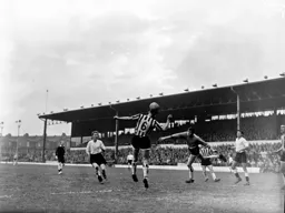 The ball is headed clear watched by Mark Lownds and Tommy McKechnie
