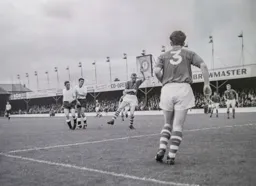 Jim Goldie and Gordon Turner both attack the ball