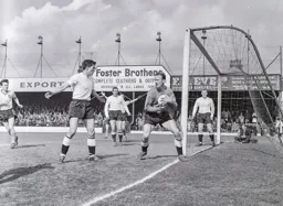 Ron Baynham safely hold on to the ball