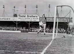 Ron Davies challenges the goalkeeper