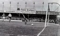 The ball seems to be headed wide watched by Ron Davies