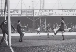 Gordon Turner dives to head home