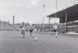 Ray Whittaker in a race for the ball with Roy McCrohan with David Pleat in support
