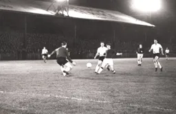 Ron Baynham comes out quickly to clear the ball