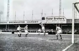 Bruce Rioch waits as the ball is headed clear