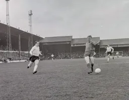 Graham French races in as Jimmy Grummett attempts a back pass