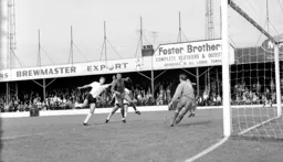 Alan Rivers challenges for the ball