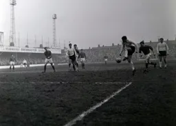 Gordon Riddick and Derek Kevan watch as Ray Whittaker lines up a shot at goal