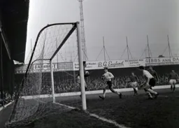 Gordon Riddick rushes in but Barnsley keeper Ray Wood holds on to the ball
