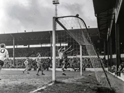 Gordon Riddick and Southport keeper Brian Reeves can only watch as the ball drifts over the cross bar