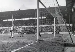 Southport keeper Brian Reeves makes a save as Derek Kevan waits hopefully in case the ball comes loose