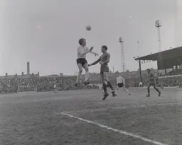 A leaping Keith Allen gets his head to the ball