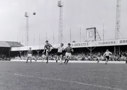 A hefty clearance keeps the ball away from Keith Allen