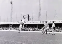 Bruce Rioch gets up to head the ball forward