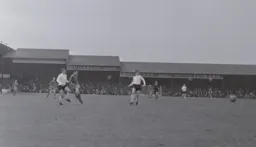 Fred Jardine and Billy McDerment cannot stop Ernie Phythian from taking a shot at goal