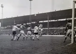 Keith Allen goes for a high ball against Peter Neale