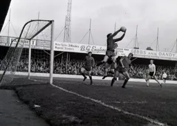 Workington keeper Ian Ower catches the ball under pressure from Ray Whittaker