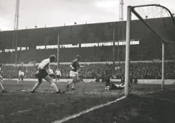Bradford keeper John Hardie smothers the ball as Ian Buxton waits in case the ball came loose