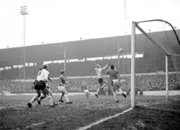 Keith Allen attempts to head in a cross watched by Ian Buxton
