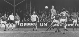 Ian Buxton gets his head to the ball watched by Keith Allen and Graham French