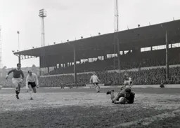 Port Vale keeper Stuart Sharratt dives on to the ball as Ian Buxton follows