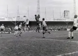 Mick Rose makes sure the ball does not reach Ian Buxton